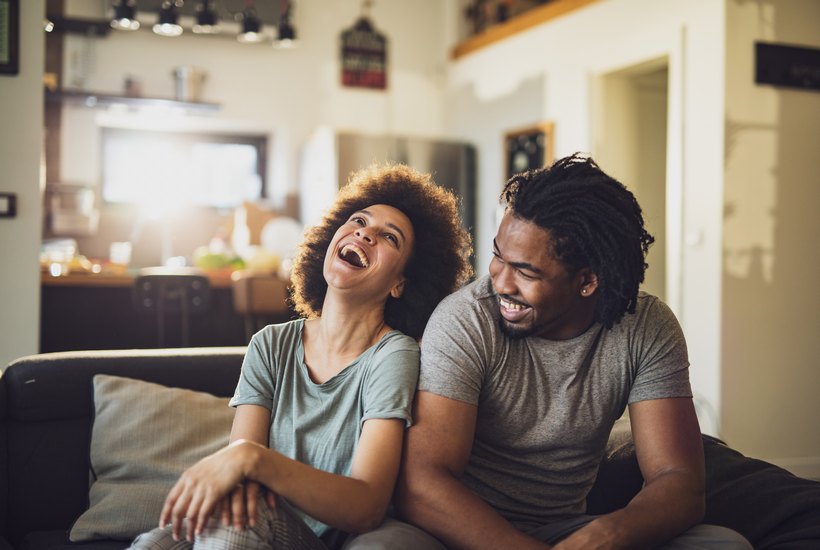 Young Cheerful African American Couple In The Living Room 