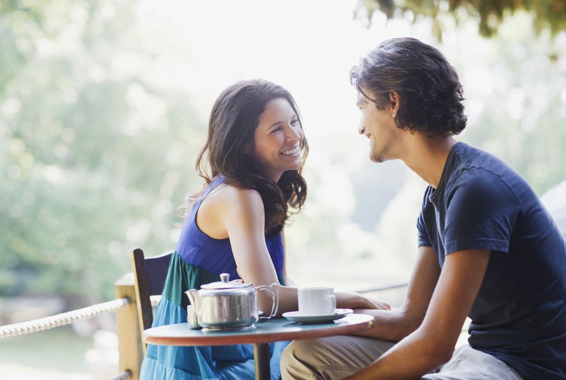 Smiling Couple Having Tea Outdoors