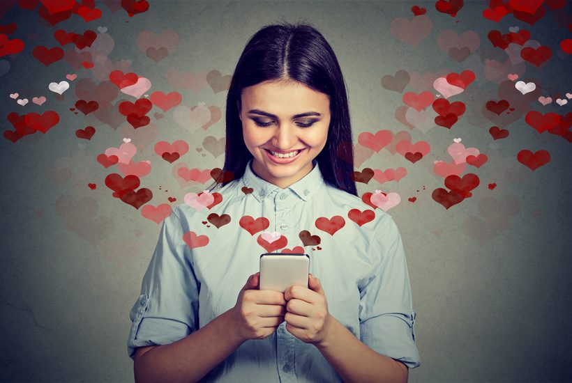 Beautiful Happy Woman Sending Love Text Message On Mobile Phone